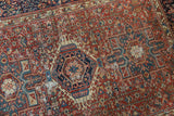 Detail of a vintage Karaja rug's indigo medallion and geometric field showing authentic, isolated wear.