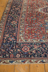 Corner of Vintage Karaja rug, showing fringed edge and stylized blue, red bird border.