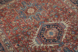 Vintage Karaja rug's intricate geometric patterns with black cherry red, indigo blue, and cream.