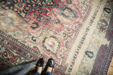 Distressed antique Khorassan rug detail, showing faded fuscia, powder blue floral motifs, and worn pile.