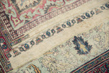 Worn floral pattern and Laleh Abassi border detail on antique Distressed Khorassan rug.