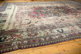 Intricate main border with floral and palmette motifs on the distressed Khorassan rug.