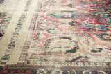 Distressed texture and faded red, blue floral pattern on antique Khorassan rug.