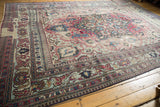 Distressed Antique Khorassan carpet with Laleh Abassi pawn border and floral designs.