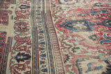 Distressed antique Khorassan rug with faded fuscia florals and blue Laleh Abassi border.