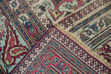 Antique distressed Khorassan rug corner showcasing Laleh Abassi border and vibrant jewel tones.