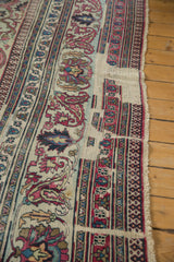 Detail of antique distressed Khorassan carpet showing worn border, geometric patterns, and secured edge.