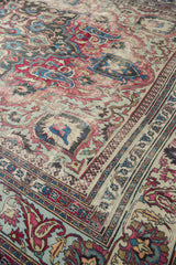 Antique Khorassan carpet corner, featuring distressed Laleh Abassi pawn motifs and fuscia, blue floral details.