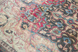 Patina of an antique distressed Khorassan rug, highlighting faded fuchsia, cobalt blue, and ivory motifs.