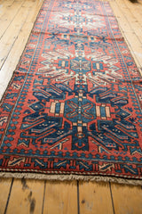 Rounded geometric medallions of a vintage Karaja runner in navy blue and brick red.