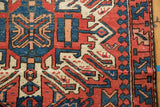 Vintage Karaja rug runner: geometric pattern detail with border in brick red, navy, and ivory.