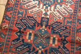 Hand-knotted vintage Karaja rug with geometric motifs in brick red and navy blue.