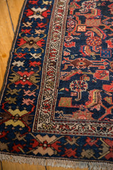 Angled view of the crab palmette border and low wool pile on a vintage Persian Malayer runner.