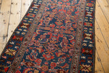 Rich indigo and brick red tones in the crab palmette border of a vintage Malayer runner.