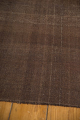 Hand woven texture of the vintage Turkish Kilim rug, showing chocolate brown and warp details.