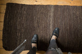 Dynamic hand woven texture of a Turkish Kilim in dark chocolate and coffee brown.