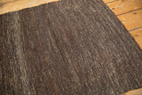Handwoven texture of vintage Turkish Kilim rug, dark chocolate and coffee brown hues, secured edge.