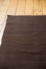 Woven brown hues and subtle texture of a vintage Turkish Kilim rug runner.