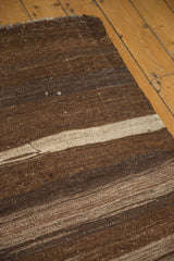 Handwoven Turkish Kilim rug with dark chocolate, coffee brown, and ivory striated stripes.