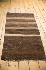 Hand woven vintage Turkish Kilim rug displaying horizontal stripes with striated abrashes in brown and ivory hues.
