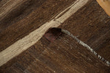 Vintage Turkish Kilim rug's secure fringed end, dark brown weave, and stitched label.