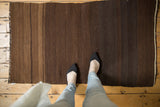 Vintage Turkish Kilim rug showing hand woven texture, brown striated abrashes, and stripes.