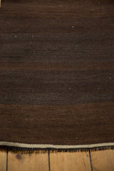 Vintage Turkish Kilim rug texture, brown horizontal bands with subtle abrashes, and fringe.