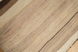 Turkish Kilim rug showing striated ivory, coffee brown, and dark chocolate stripes.
