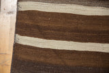 Vintage Turkish Kilim runner edge: hand-woven brown and ivory horizontal striated stripes.