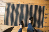 Textured neutral toned striped vintage Kilim runner underfoot.