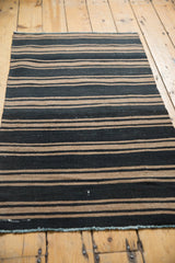 Hand-woven geometric Turkish Kilim runner with charcoal black and khaki stripes, light blue edge.
