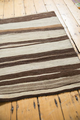 Striated hand woven texture of vintage Turkish Kilim with ivory and brown stripes.