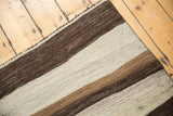 Repeating striated ivory, coffee brown, and dark chocolate horizontal bands.