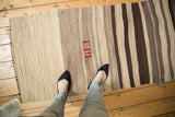 Vintage Turkish Kilim runner with striated ivory, coffee, chocolate bands and red insignia.