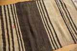 Textured distressed Turkish Kilim with coffee brown, ivory stripes, and a faded red patch.
