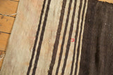 Distressed Turkish Kilim's textured ivory, brown, faded blush stripes with distinct red repair.