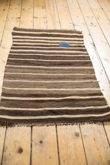 Striped hand woven Moroccan kilim runner in brown and beige with a charming blue patch.