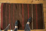 Handwoven Turkish Kilim with striated coffee brown, wine red, and ivory horizontal bands.