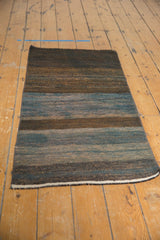 Hand woven Turkish Kilim rug runner texture with blended charcoal, slate, khaki, and blue stripes.