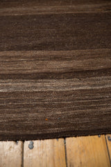 Angled close-up of vintage Turkish Kilim runner with coffee brown and ivory striated abrashes.