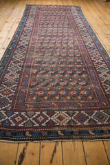 Antique Kuba rug end with geometric red, navy, blush border and secured fringe.
