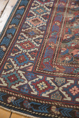 Antique Kuba runner with geometric tribal patterns, wine red, navy blue, and visible foundation.