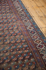 Antique Kuba runner featuring allover floral motifs and a distinct geometric border.