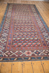 Early 20th century Caucasian Kuba runner end, with intricate navy and blush geometric borders and secured fringe.