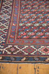 Intricate geometric border of the antique Kuba runner in navy, red, and ivory.