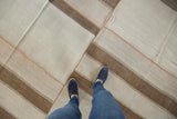Patchwork kilim with ivory and coffee brown banded stripes, stitched in terracotta.