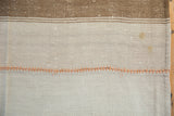 Dusty terracotta stitches in professionally reinforced seam of vintage Turkish kilim.