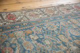 Distressed vintage Malayer runner featuring Herati motif and classic floral border in muted blue and terracotta.
