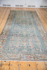 Distressed Malayer runner, detailed view of classic floral border and faded blue Herati field.