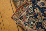 Detail of a vintage Kurdish runner's folded edge, showing navy, madder, and beige Veramin pattern.